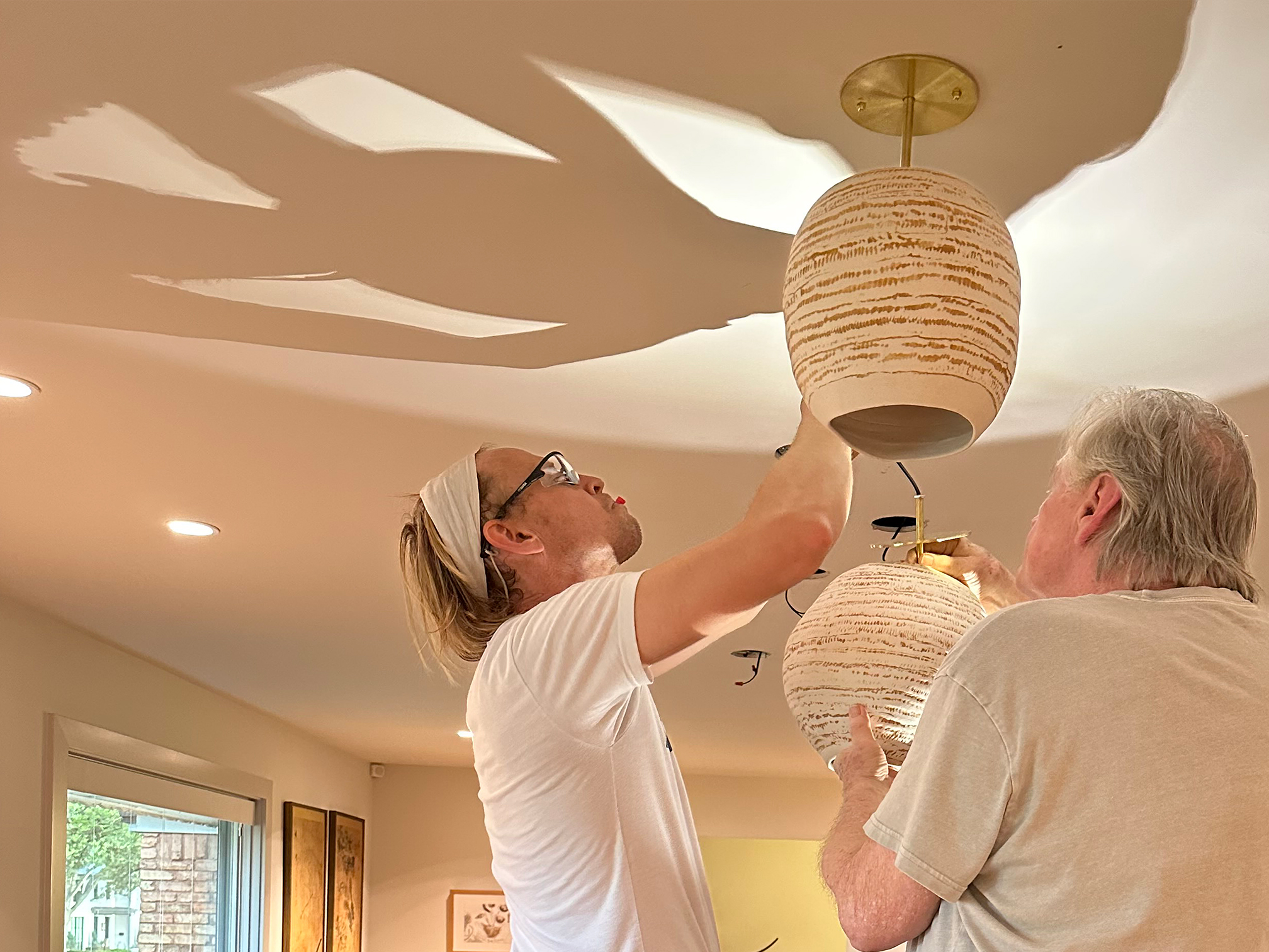 installing and lifting porcelain lights created by Lisa Ehrich